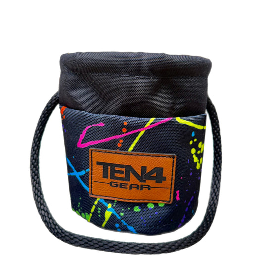 Splatter Grunt Sack, black bag with colorful splatter pattern, rope handle, and logo patch