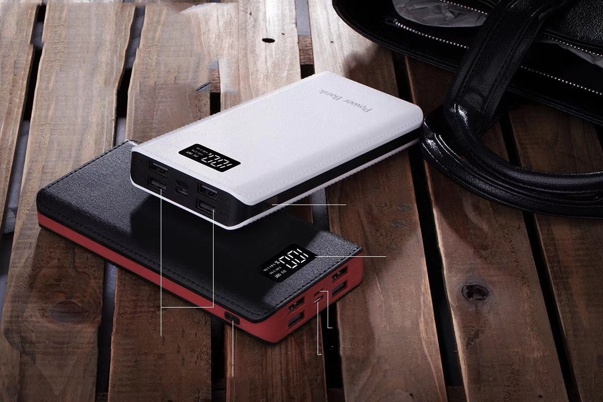 White power bank resting on its packaging on a wooden bench