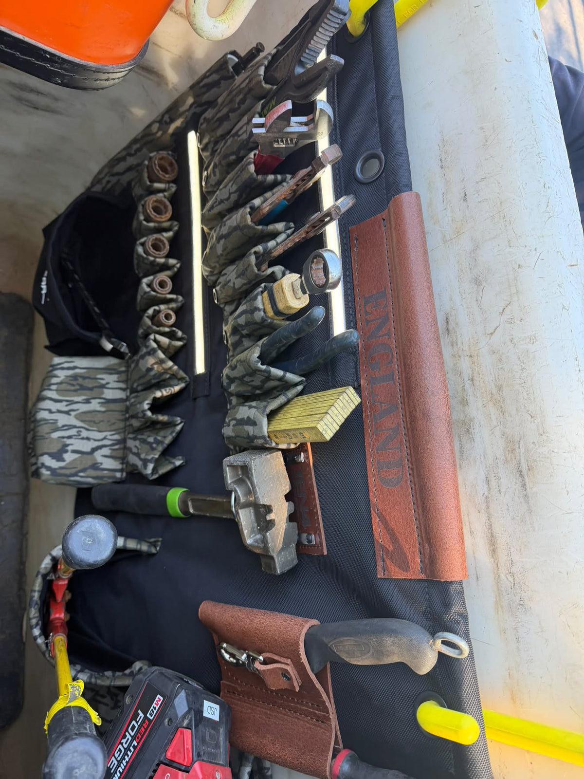 32″ G Board – Lighted Lineman Tool Board, loaded tool pockets viewed from the side in a work bucket