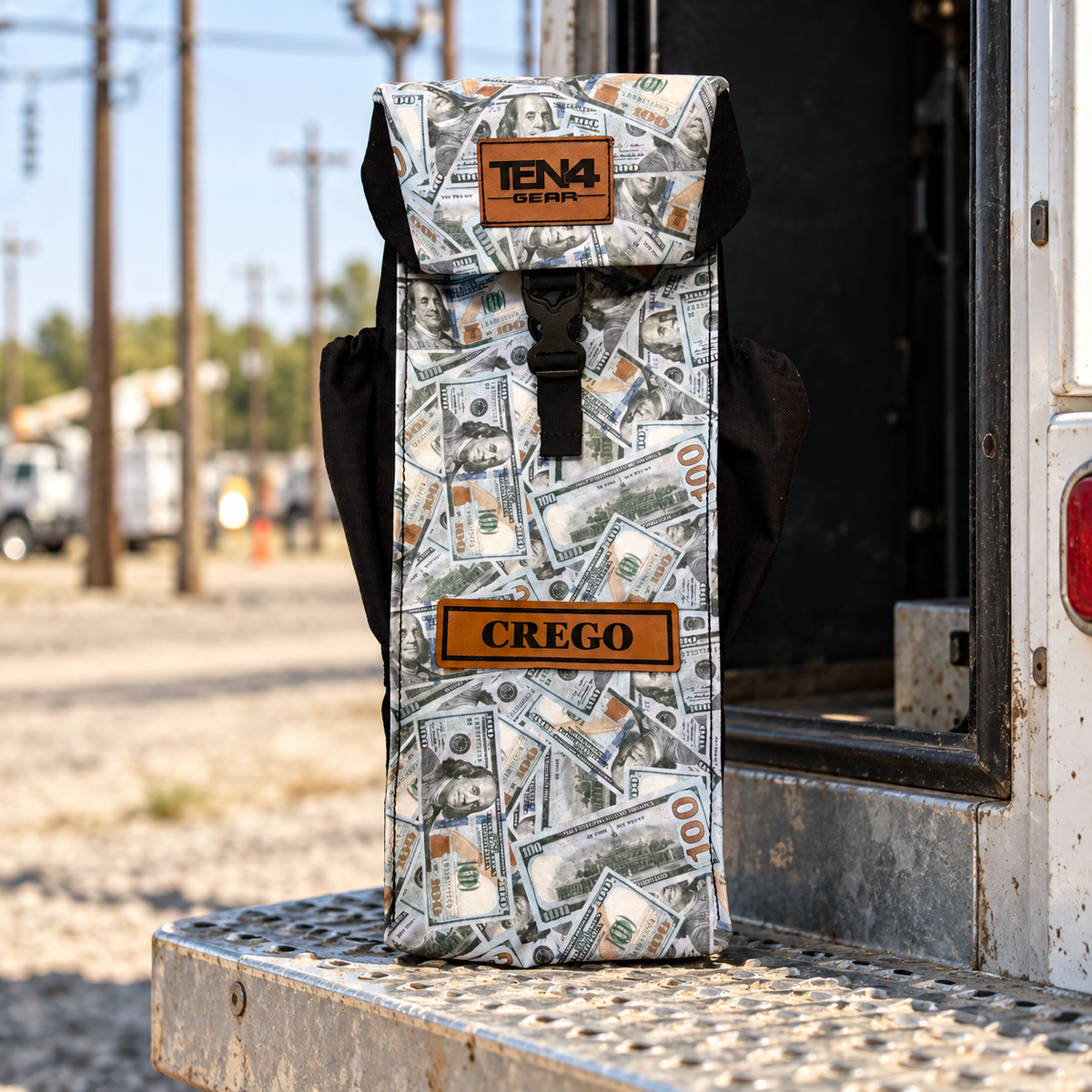 Blue Strips money-print Utility bag with formed buckle lid and side pockets beside a utility truck