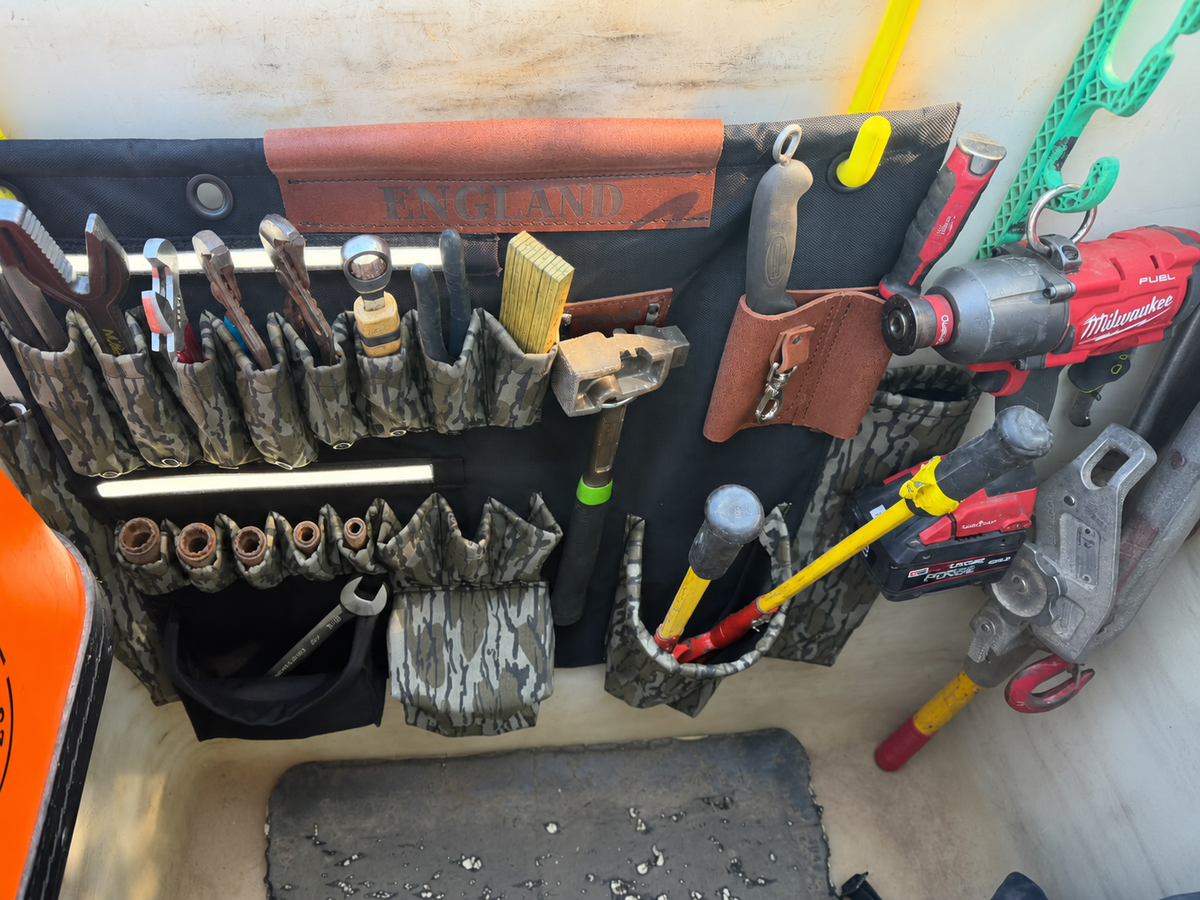 32-inch TEN4 G-Board loaded with tools in a work bucket, with its integrated light strips on; edited photo oriented upright.