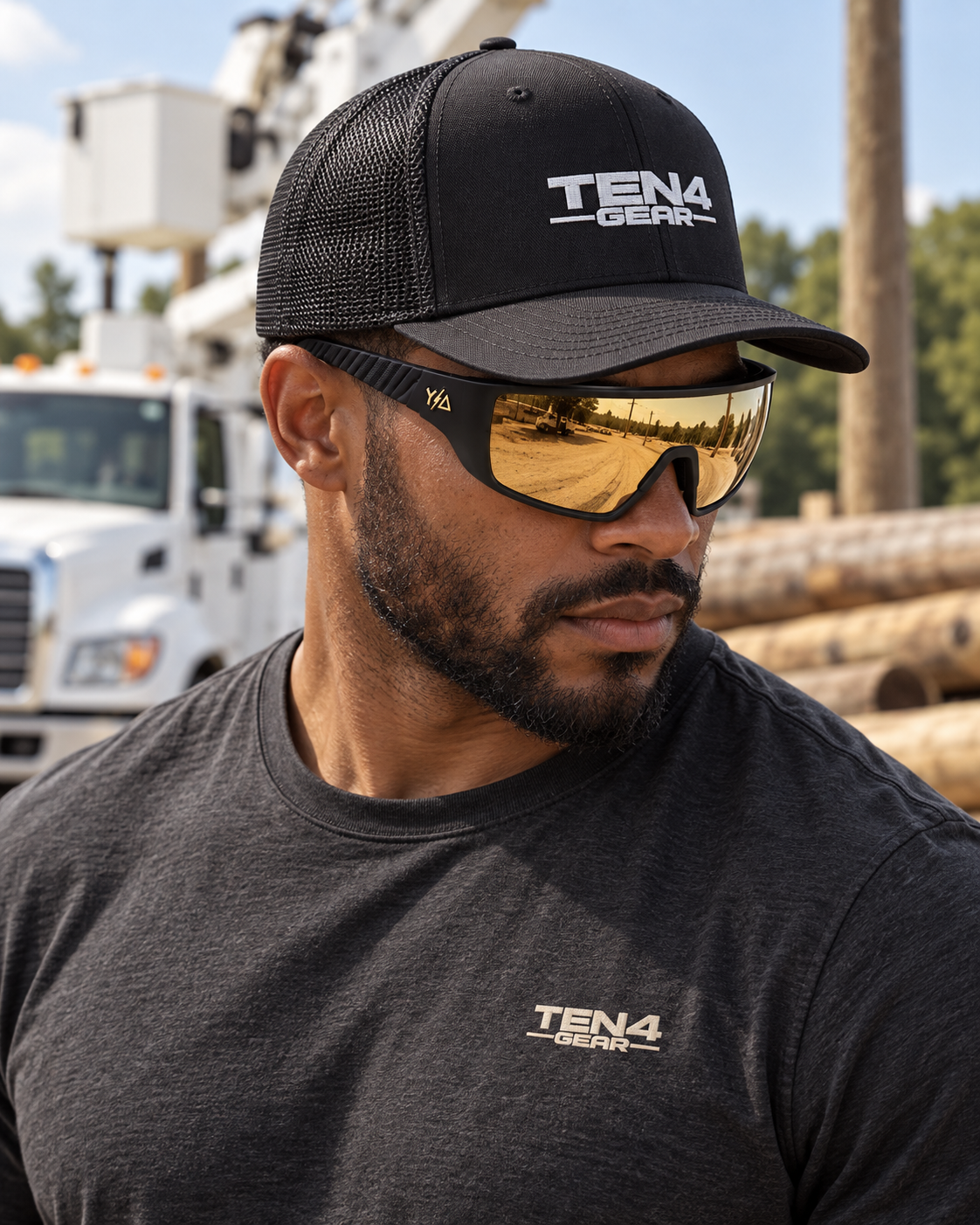 Lifestyle model mockup wearing Wye Delta Conductors Amber Gold sunglasses, black TEN4 Signature hat and charcoal TEN4 shirt.