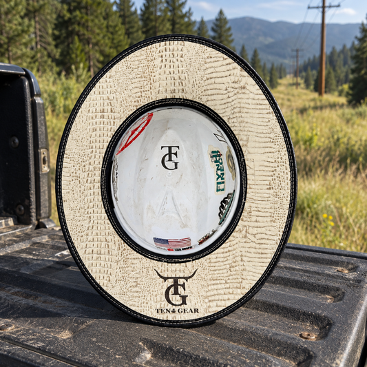 Bone gator sunshade on a pickup tailgate beside a powerline right-of-way