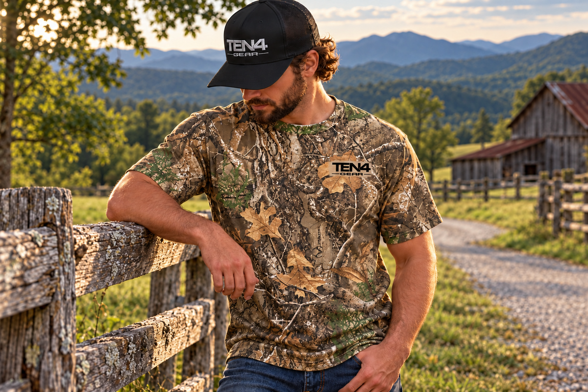TEN4 Country Roots Tee model photo — Realtree EDGE woodland camouflage, black TEN4 logo over faded tan backing