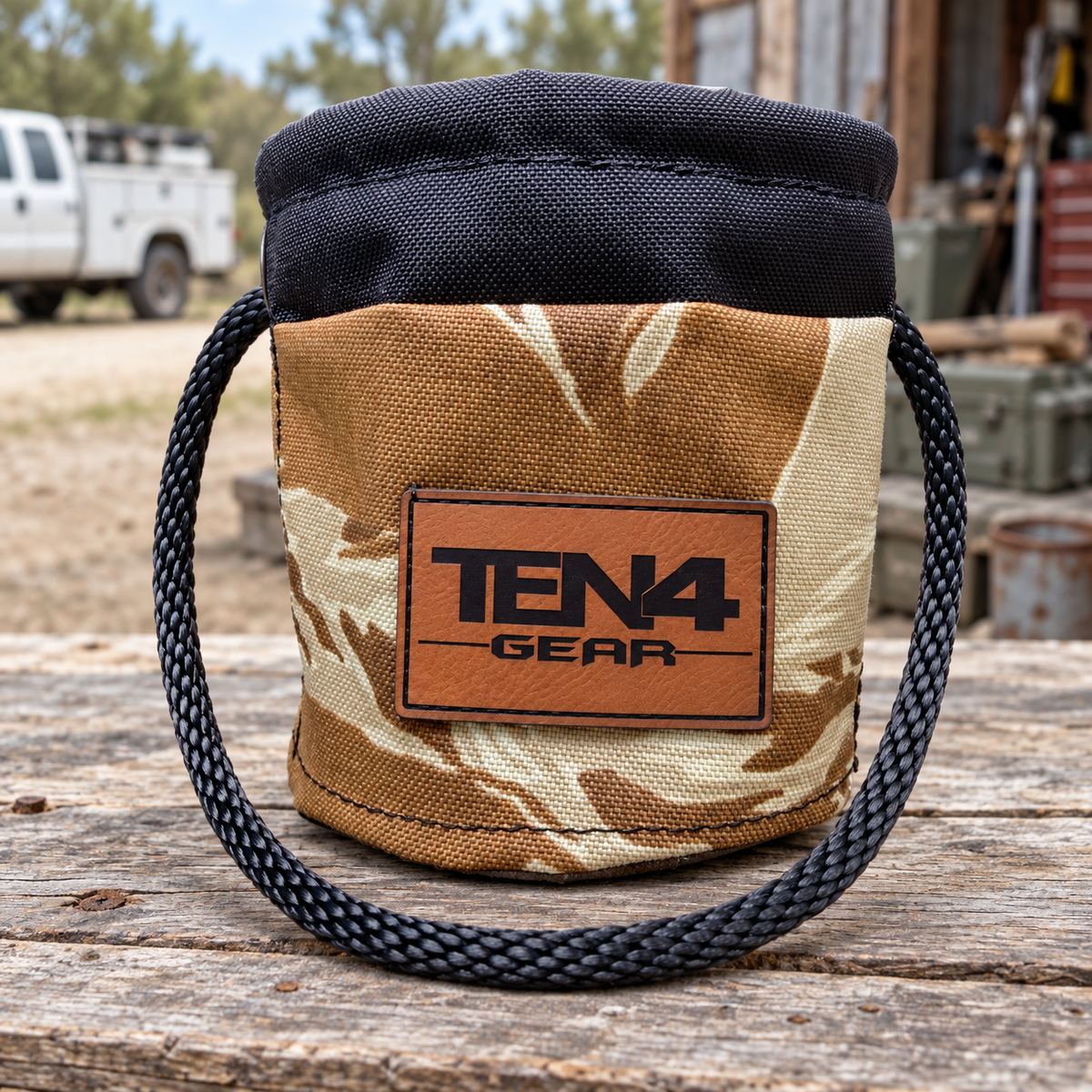 Desert Tiger Stripe Grunt Sack with current TEN4 patch on a rustic workbench