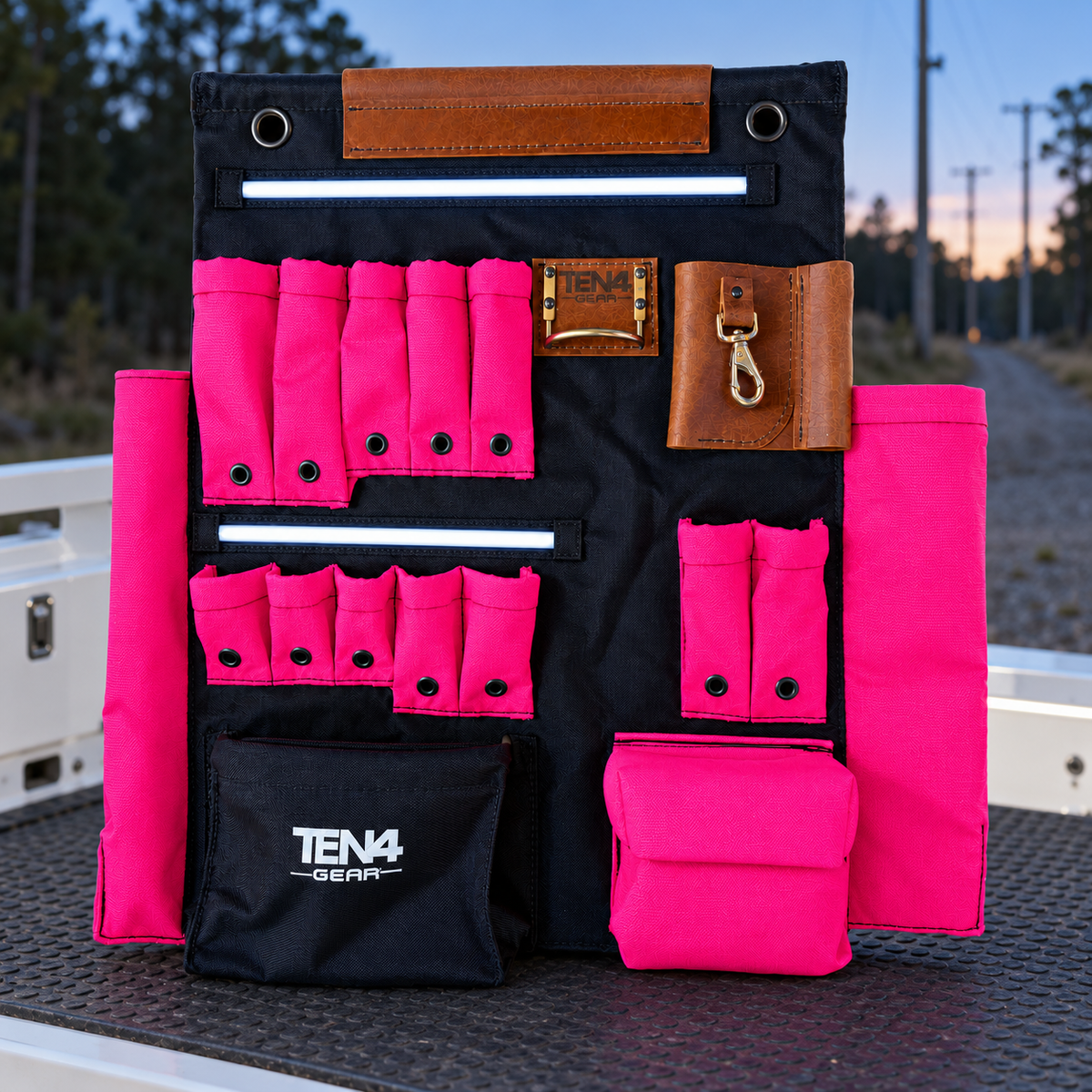 Electric Pink 24-inch TEN4 G Board with white LED glow at an outdoor utility worksite