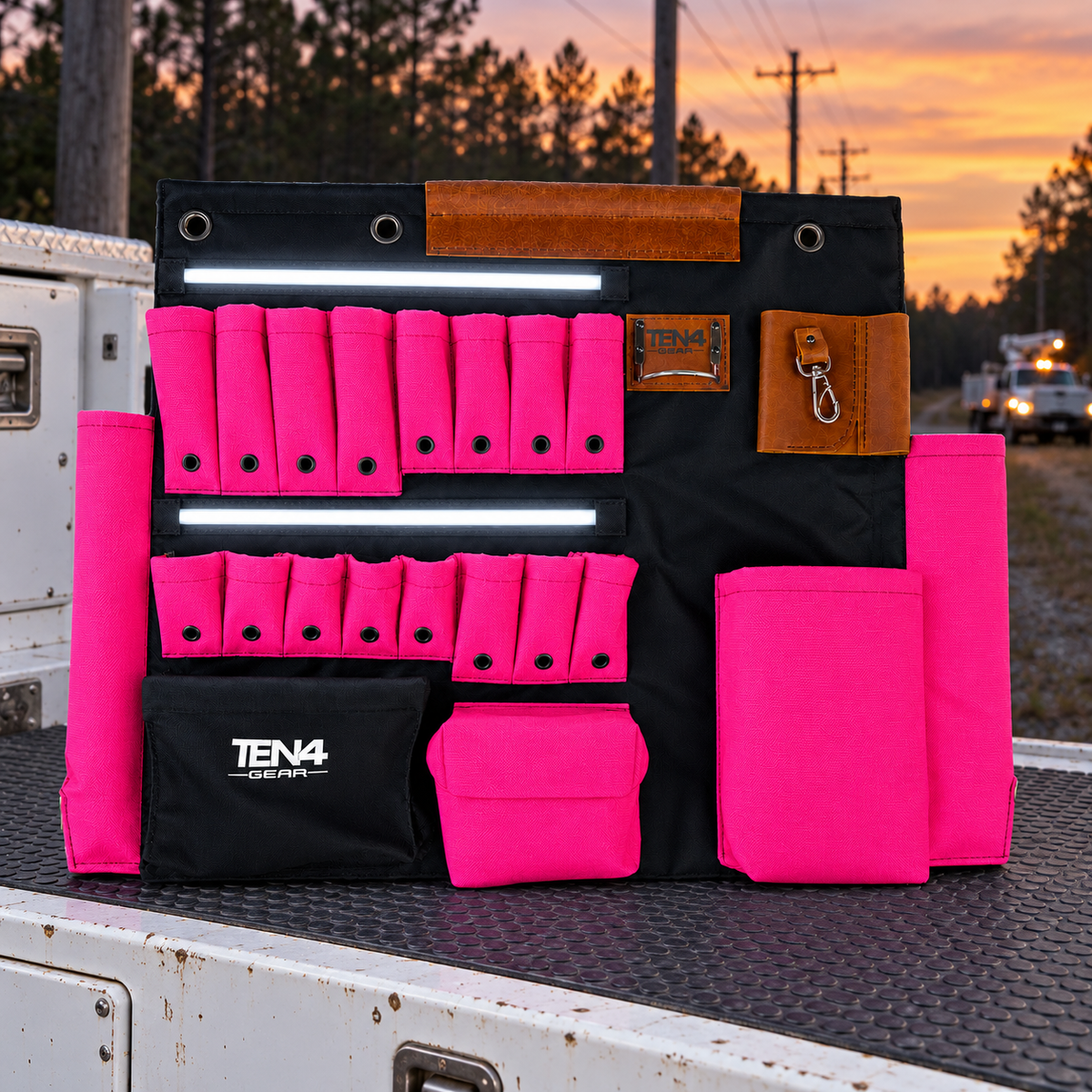 Electric Pink 32-inch TEN4 G Board with white LED glow at an outdoor utility worksite