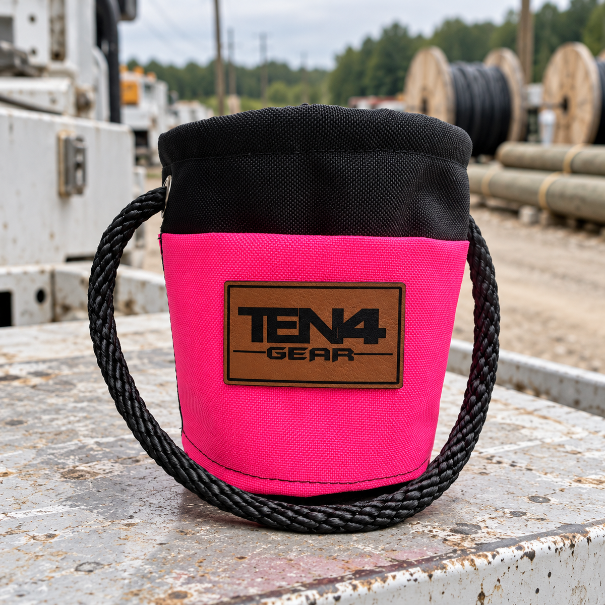 Electric Pink Grunt Sack with current TEN4 patch on a utility truck at an outdoor linework site