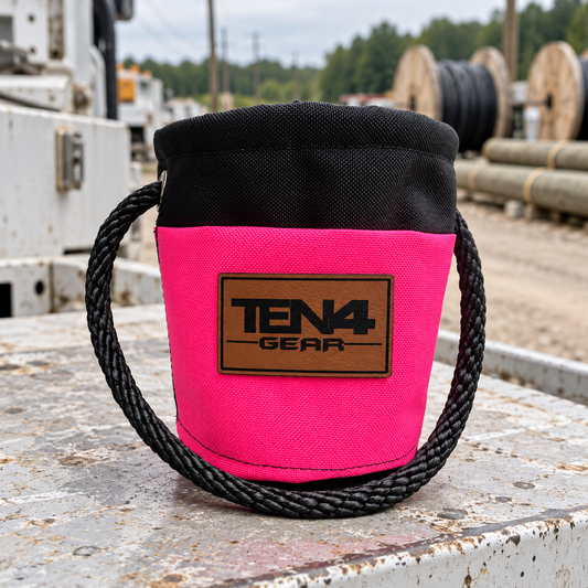 Electric Pink Grunt Sack with current TEN4 patch on a utility truck at an outdoor linework site