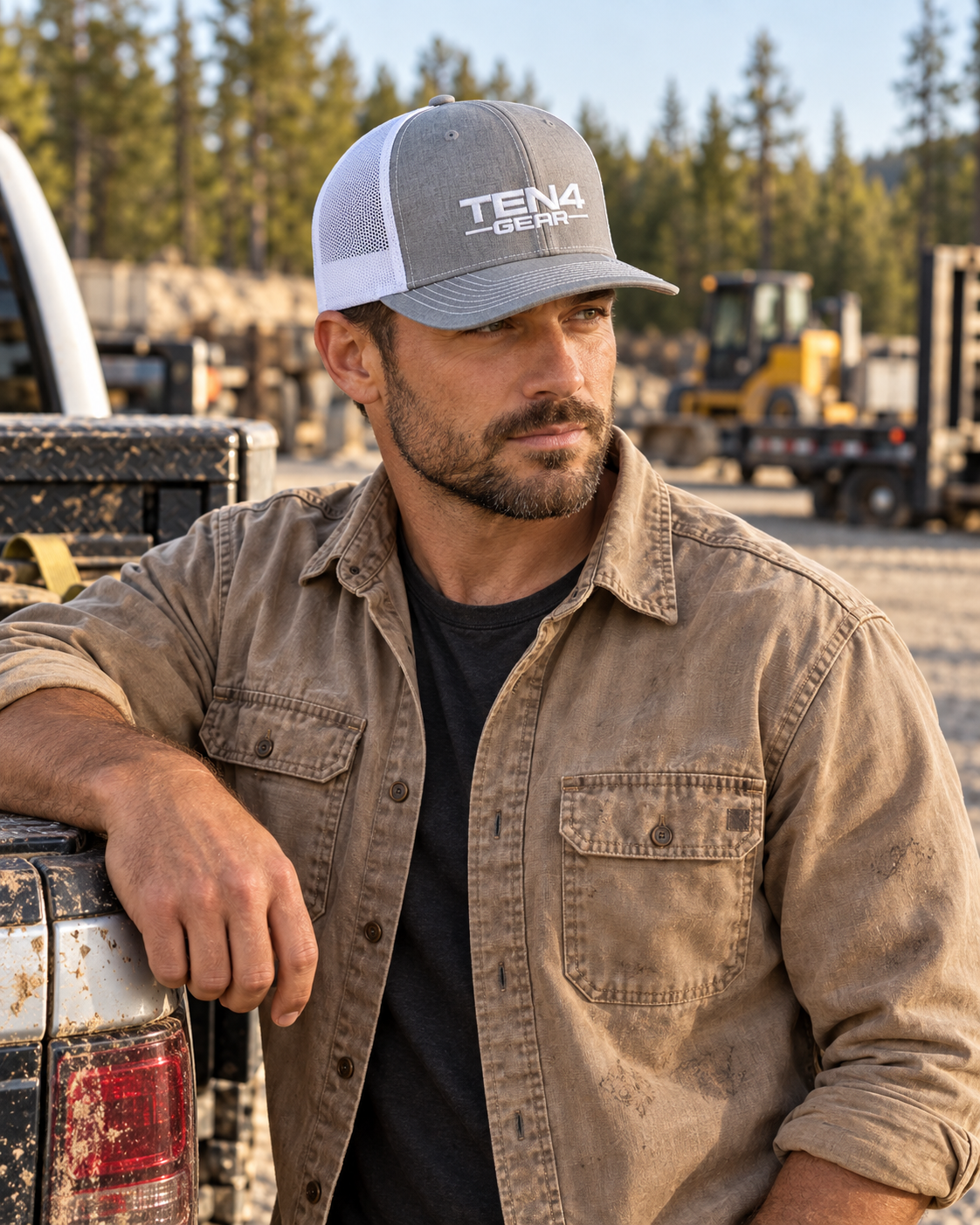 Heather gray and white TEN4 full-logo hat with white embroidery, worn by a man standing beside a work truck looking away