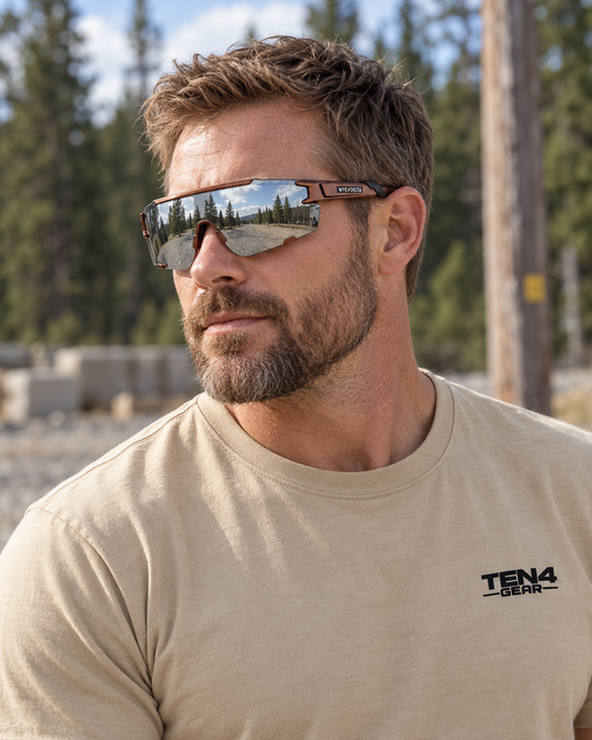 Lifestyle model mockup wearing Wye Delta HiViz Copper sunglasses and TEN4 HIGH LINE Sand tee.