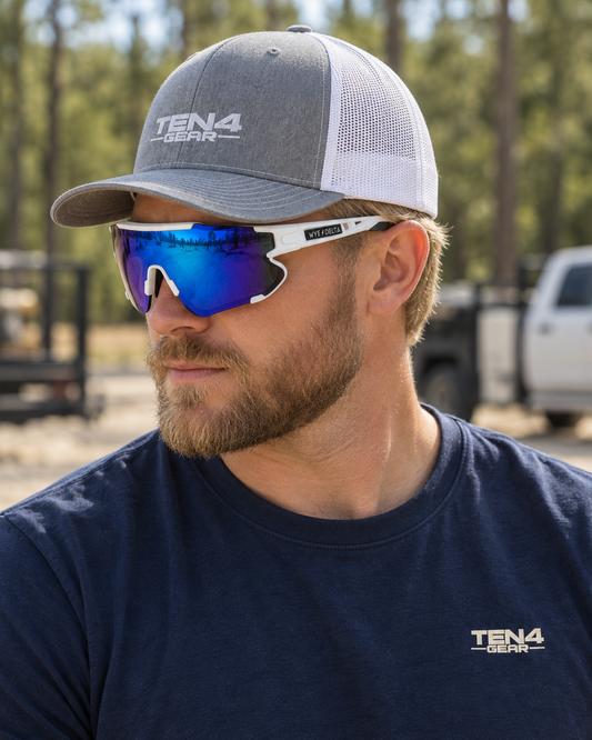 Lifestyle model mockup wearing Z87+ HiViz White Deep Blue Mirror and TEN4 apparel outdoors.