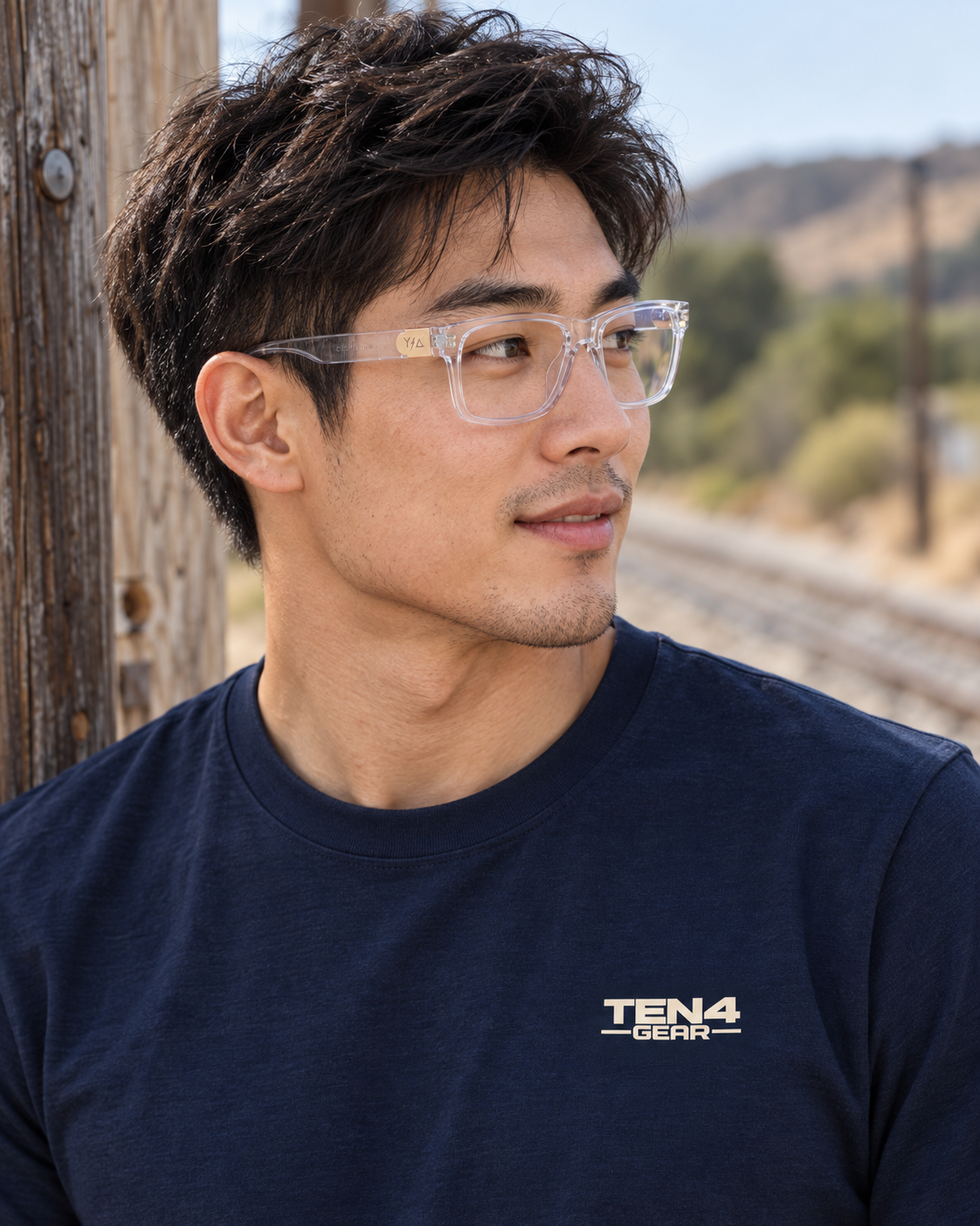 Lifestyle model mockup wearing Z87 MADHOOK2.0 LR: CLEAR and TEN4 apparel outdoors.