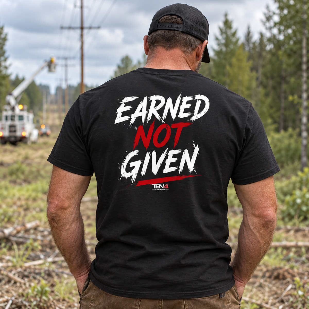 Original TEN4 Earned Not Given red and white back print on black tee, outdoor model