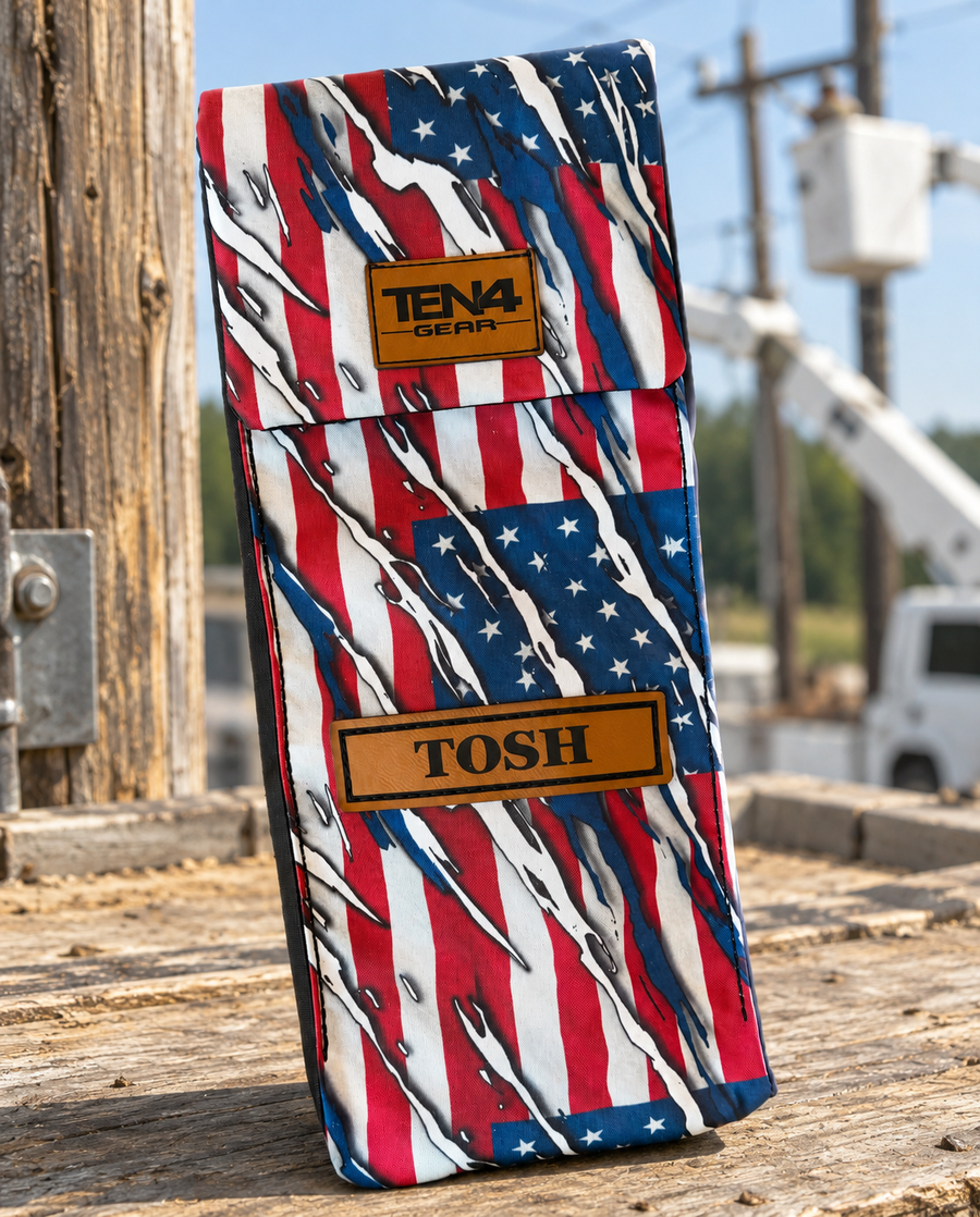 Patriot Classic bag with flat Velcro flap and personalized leather name patch — original product photo; background edited to an outdoor utility jobsite.