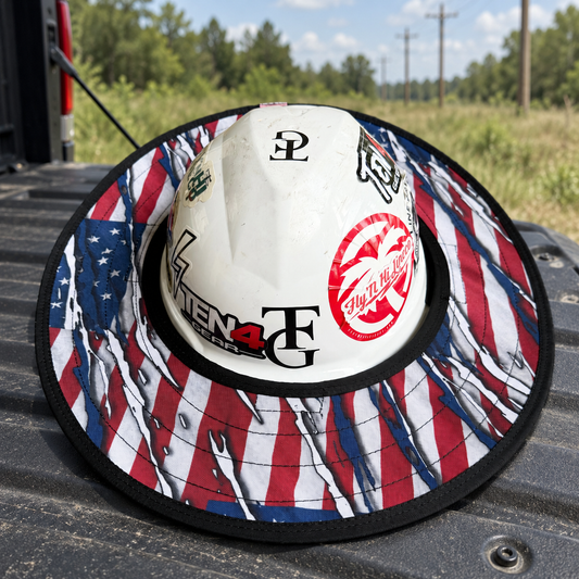 Patriot sunshade on a white hard hat on a pickup tailgate at a rural utility right of way