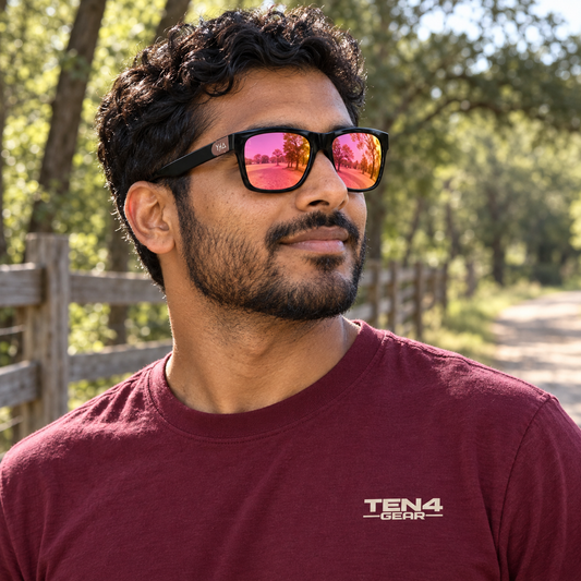 Lifestyle model mockup wearing Z87 MADHOOK2.0 LR: PINK REVO POLARIZED with TEN4 apparel outdoors.