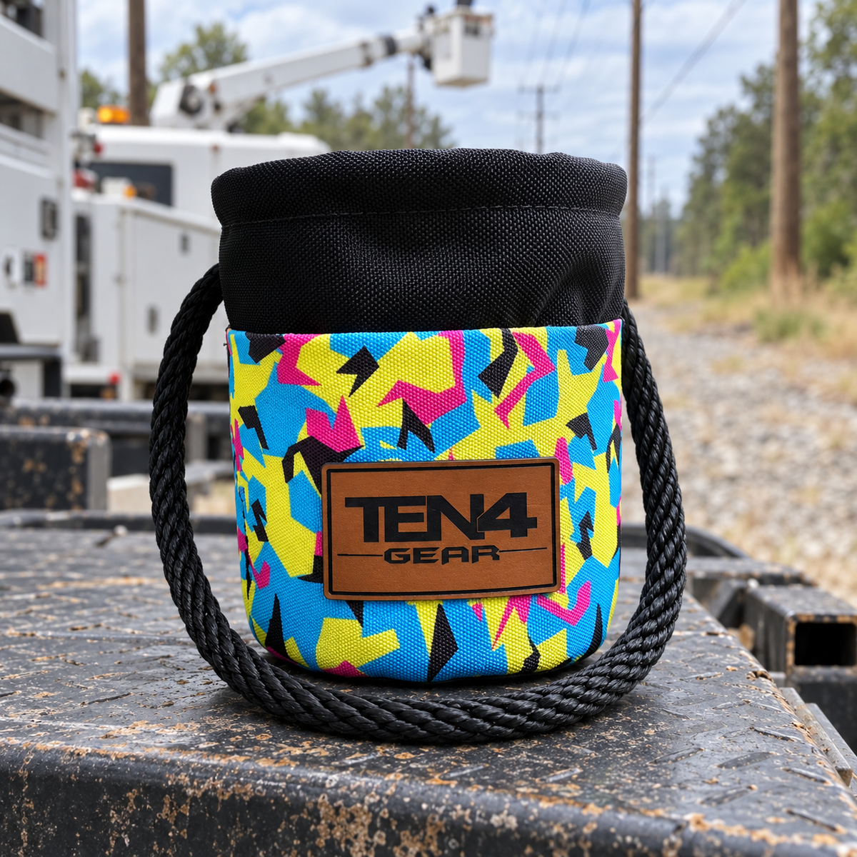 Pop Rock Grunt Sack with current TEN4 patch on a utility truck at an outdoor linework site