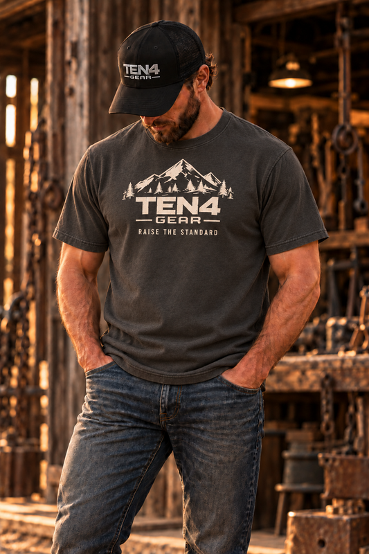 TEN4 Raise the Standard tee in Pepper, shown on our bearded model in a rustic workshop.