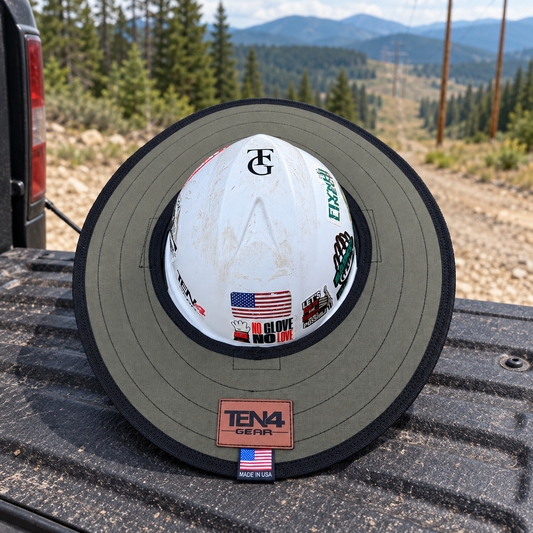 Ranger Green sunshade on a pickup tailgate beside a mountain powerline