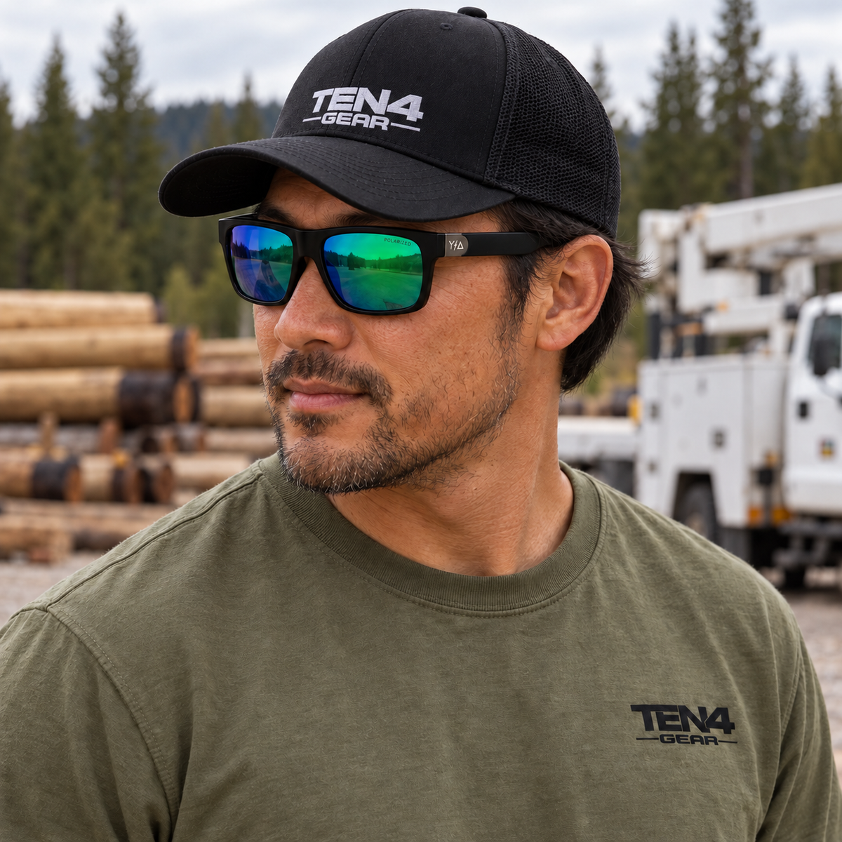 Lifestyle model mockup wearing Z87 MADHOOK2.0 LR: GREEN REVO POLARIZED with TEN4 apparel outdoors.