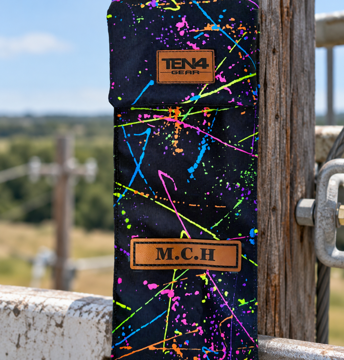 Splatter Classic flat Velcro flap and personalization detail — original product photo; background edited to an outdoor utility jobsite.