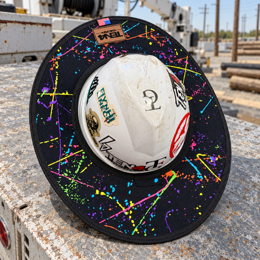 Splatter hard hat sunshade with current rear TEN4 patch on a utility truck at an outdoor linework site