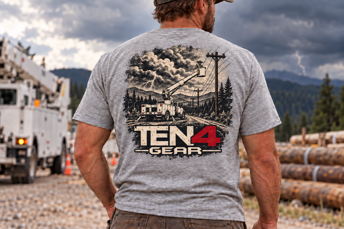 TEN4 Storm Tee in Sport Grey — larger distressed back print with lineman in a single bucket, utility truck and storm scene; model outdoors.