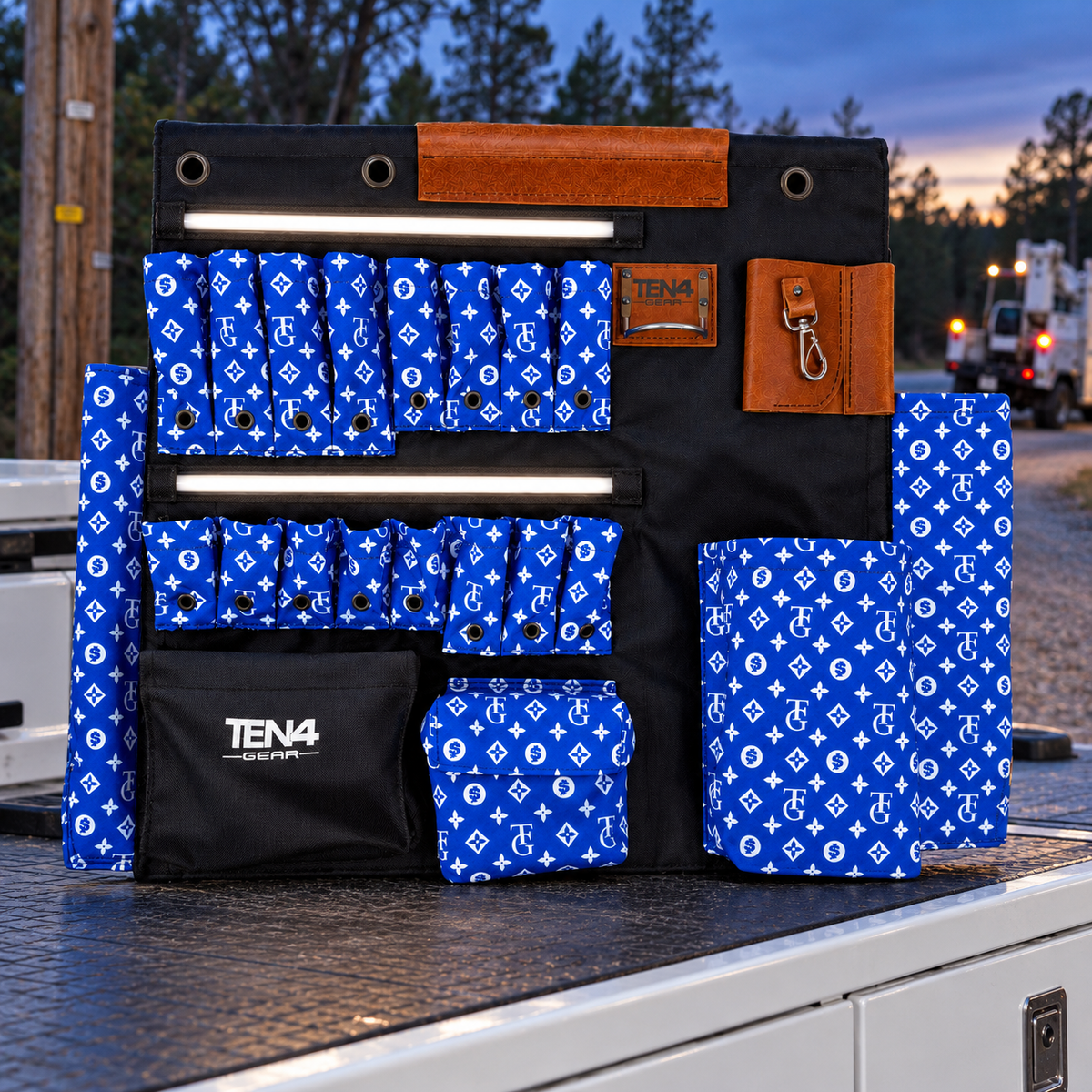 TG Royal 32-inch TEN4 G Board with illuminated LED strips on a utility truck at dusk