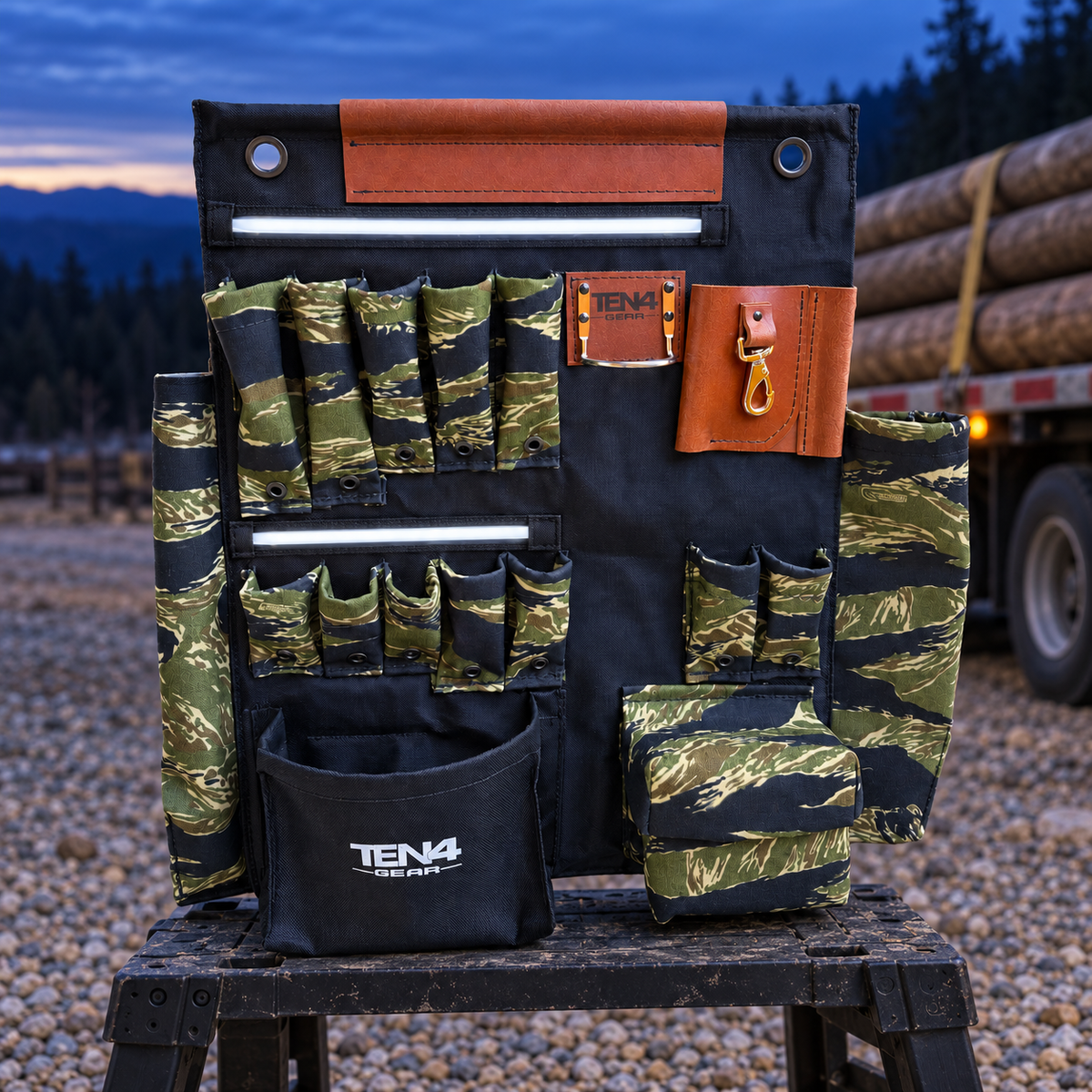 Tiger Stripe 24-inch TEN4 G Board with white LED glow beside a utility pole delivery trailer at dusk