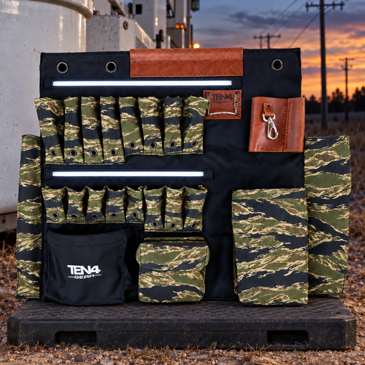 Tiger Stripe 32-inch TEN4 G Board with white LED glow beside a bucket truck at dusk