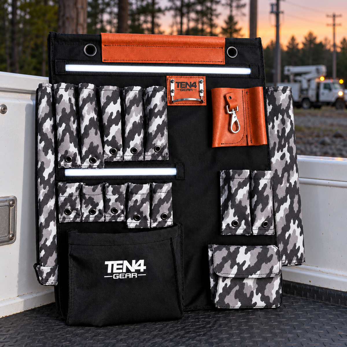 Urban Camo 24-inch TEN4 G Board with white LED glow at an outdoor utility worksite